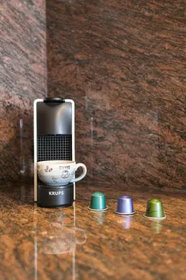a cell phone and a coffee cup on a counter at Art House Sagrada Familia in Barcelona