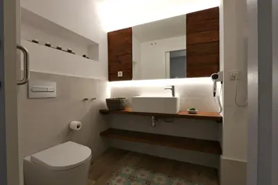 a bathroom with a sink and a toilet and a mirror at ClassBedroom Port Ramblas in Barcelona