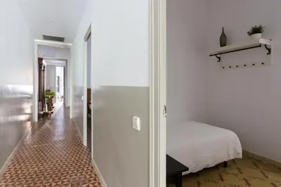 a white room with a bed and a hallway at Casa Cosi - Mallorca 2 in Barcelona