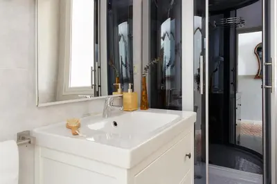 a bathroom with a white sink and a mirror at Casa Cosi - Mallorca 2 in Barcelona