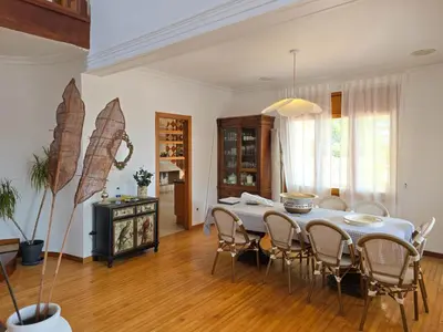 a dining room with a table and chairs at Villa El Faro by Hello Homes Sitges in Vilanova i la Geltrú