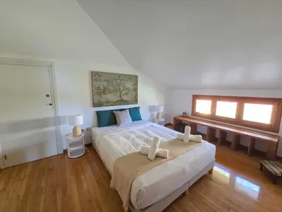 a bedroom with a large bed and a window at Villa El Faro by Hello Homes Sitges in Vilanova i la Geltrú