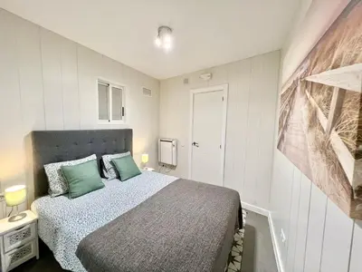 a bedroom with a bed with green pillows at Cozy Suite apartment, WiFi! in Santa Coloma