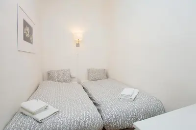 a white bathroom with a toilet and a sink at Gaudi Sagrada Familia in Barcelona