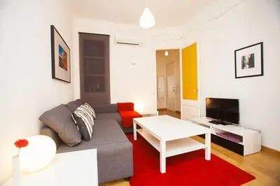 a bedroom with a red curtain and a table and chairs at Gaudi Sagrada Familia in Barcelona
