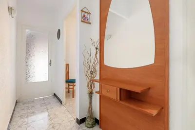 a hallway with a wooden door with a mirror at Besos · Bright apartment close to congress & port in Sant Adria de Besos