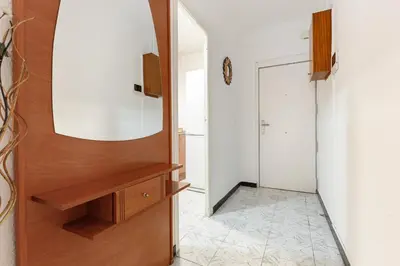 a hallway with a wooden cabinet and a mirror at Besos · Bright apartment close to congress & port in Sant Adria de Besos