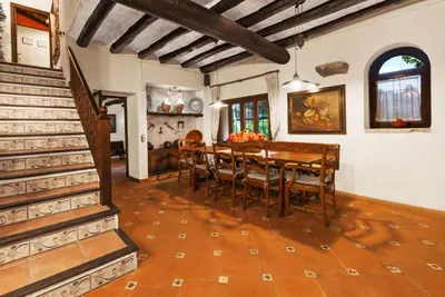a dining room with a wooden table and chairs at Comarquinal Bioresort Penedes in San Quintín de Mediona