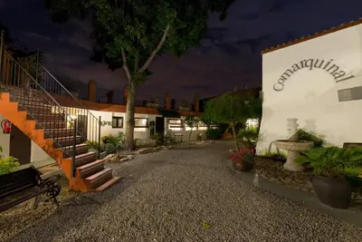 a building with a staircase in front of it at Comarquinal Bioresort Penedes in San Quintín de Mediona