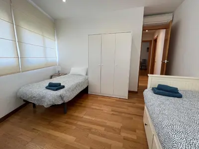 a bedroom with two twin beds and a closet at Stay Barcelona Maragall in Barcelona