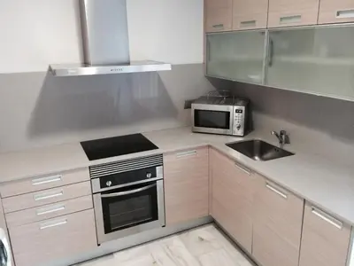 a kitchen with a sink and a microwave at Aparthotel del Golf in Sant Cugat del Vallès