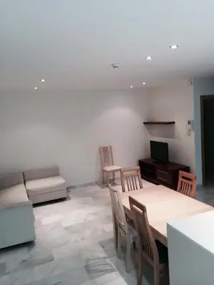 a living room with a table and a couch at Aparthotel del Golf in Sant Cugat del Vallès