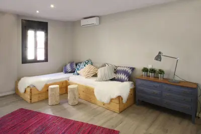 a room with a bed and a couch and a table at Fridays Flats Casa Lemonade in Hospitalet de Llobregat
