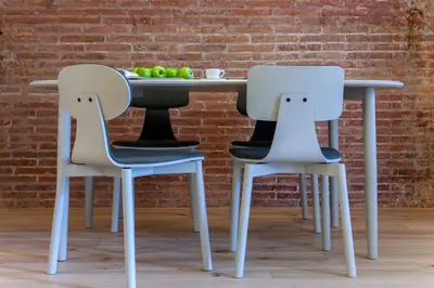 a table with two chairs and a table with fruit on it at DestinationBCN Universitat Apartments in Barcelona
