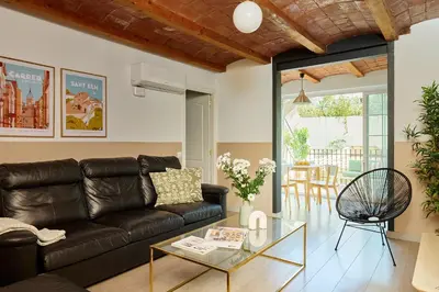 a living room with a leather couch and a glass table at Casa Cosi - Mallorca 3 in Barcelona