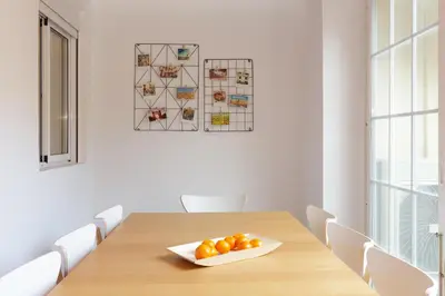 a dining room table with a bowl of oranges on it at Casa Cosi - Mallorca 3 in Barcelona