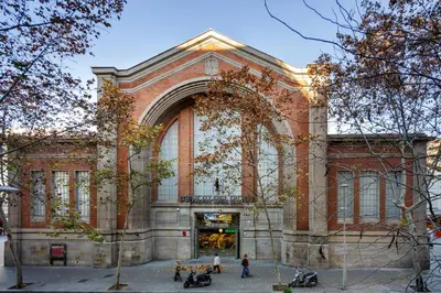a large brick building with people in front of it at Casa Cosi - Mallorca 3 in Barcelona