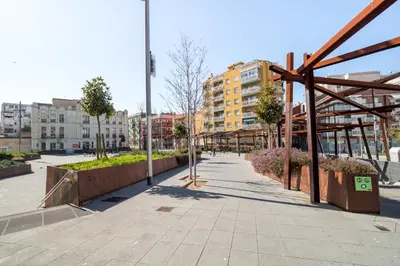 a sidewalk in a city with buildings and trees at Sweett - Callao Plaza in Barcelona