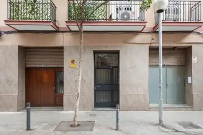 a building with a palm tree in front of it at Camp Nou , Fira Barcelona Apartment in Hospitalet de Llobregat