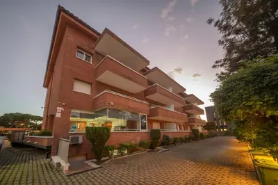 a red brick building on a street at Aparthotel Marsol in Castelldefels
