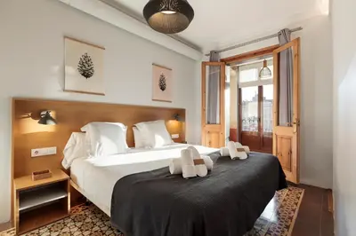 a bedroom with a large bed with two towels on it at Central Apartments Barcelona in Barcelona