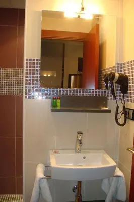 a bathroom with a sink and a mirror at Casablanca Suites - Adults Only in Calella