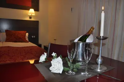 a room with a bottle of champagne and a candle on a table at Casablanca Suites - Adults Only in Calella