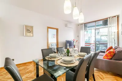 a dining room with a glass table and chairs at Confort Barcelona Rentals in Barcelona