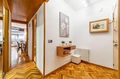a hallway with white walls and wooden flooring and a white wall at Confort Barcelona Rentals in Barcelona