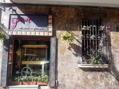 a store front with a window and a balcony at Rambla Poblenou&Mar Bella Beach in Barcelona