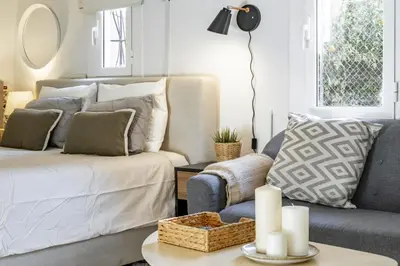a living room with a bed and a couch at NEW Renovated COZY APPARTMENT CENTRIC in Barcelona
