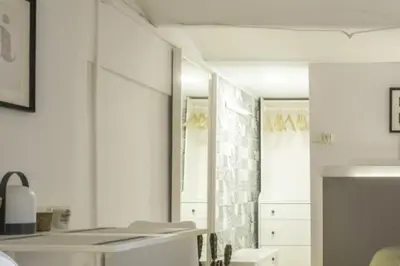 a kitchen with white cabinets and a mirror at NEW Renovated COZY APPARTMENT CENTRIC in Barcelona