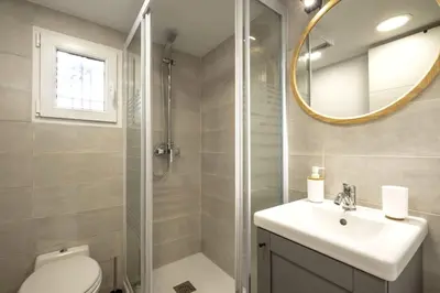 a bathroom with a toilet and a sink and a mirror at NEW Renovated COZY APPARTMENT CENTRIC in Barcelona