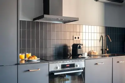 a kitchen with a stove and some food on a counter at TSA Gran Via in Barcelona