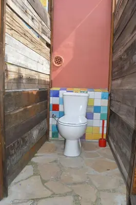 a bathroom with a toilet in the corner of a room at Entre Olivos: Very Charming Villa 18 SLEEPERS in Sant Pere de Ribes