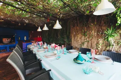 a long white table with chairs and plates and lights at Entre Olivos: Very Charming Villa 18 SLEEPERS in Sant Pere de Ribes