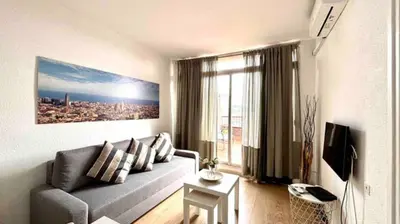 a living room with a couch and a large window at SANTS STATION PENTHOUSE in Barcelona