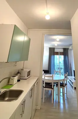 a room with two beds and a window with a mirror at Sagrada Familia - Sant Pau apartment in Barcelona