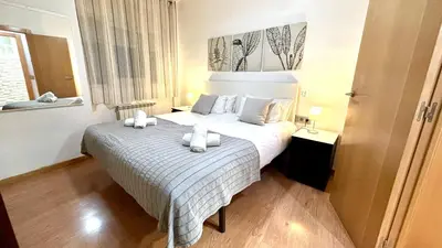 two beds in a white room with a window at Sagrada Familia Attic - Terrace Bcn Views in Barcelona