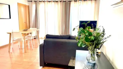a living room with a couch and a table at Sagrada Familia Attic - Terrace Bcn Views in Barcelona