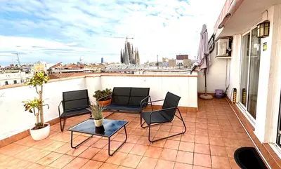 a balcony with a table and chairs on a roof at Sagrada Familia Attic - Terrace Bcn Views in Barcelona