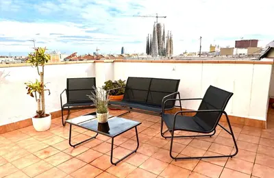 a balcony with couches and tables on a roof at Sagrada Familia Attic - Terrace Bcn Views in Barcelona