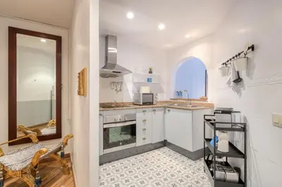 a kitchen with white cabinets and a window at Sweett - Comte Urgell in Barcelona