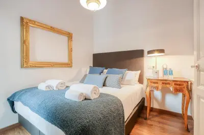 a bedroom with a bed with towels on it at Sweett - Comte Urgell in Barcelona