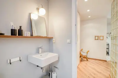 a bathroom with a white sink and a mirror at Sweett - Comte Urgell in Barcelona