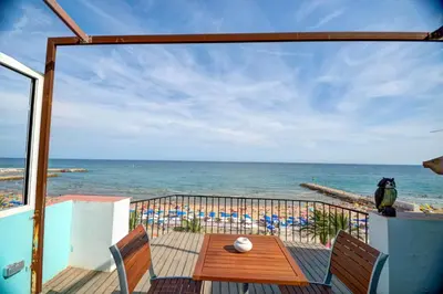 a balcony with a view of the beach and the ocean at Blue sea front by Hello Homes Sitges in Sitges