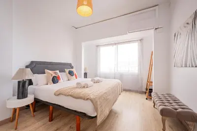 a white bedroom with a bed and a window at Sweett - The Roca House in Barcelona