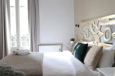 a bedroom with a large white bed and a window at Big and Bright Apartment BCN in Barcelona