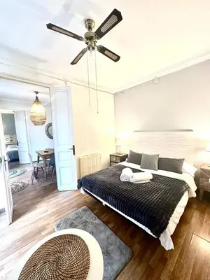 a bedroom with a bed and a ceiling fan at Big and Bright Apartment BCN in Barcelona
