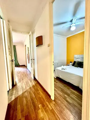 a bedroom with a bed and a ceiling fan at Big and Bright Apartment BCN in Barcelona